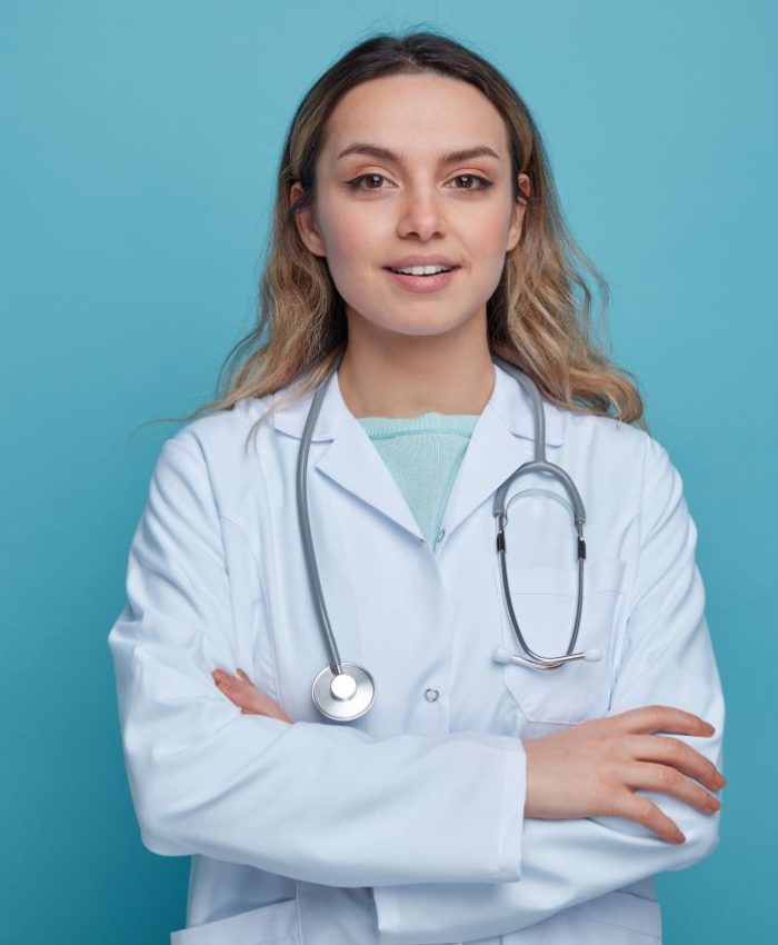 pleased-young-female-doctor-wearing-medical-robe-stethoscope-around-neck-standing-with-closed-posture