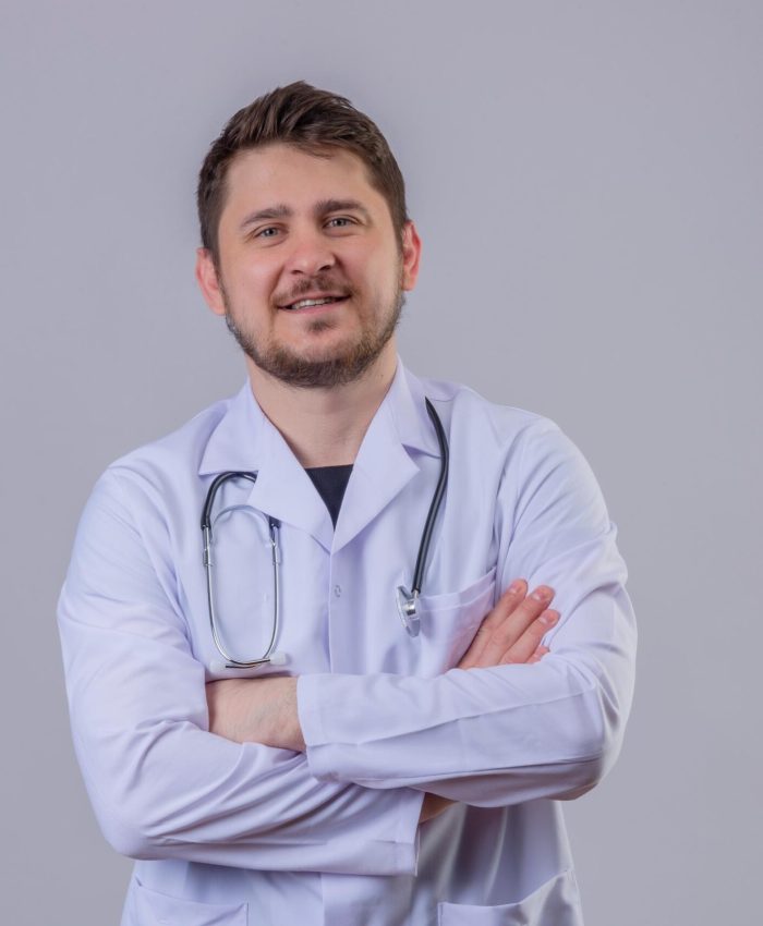 young-man-doctor-wearing-white-coat-stethoscope-looking-confident-with-crossed-arms (1)